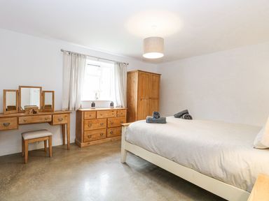 A bedroom with a bed and furniture at The Ivy in Norwich