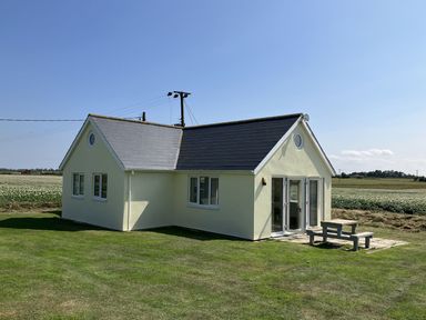 A house with a table outside at Seadrift in Bush Estate near Happisburgh