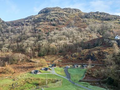 A scenic view of cabins and hills at Bluebelle - Crossgate Luxury Glamping in Hartsop