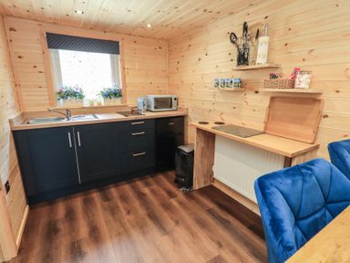 A kitchen with sink and microwave at Bluebelle - Crossgate Luxury Glamping in Hartsop