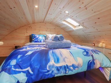 A bedroom with a bed and pillows at Bluebelle - Crossgate Luxury Glamping in Hartsop