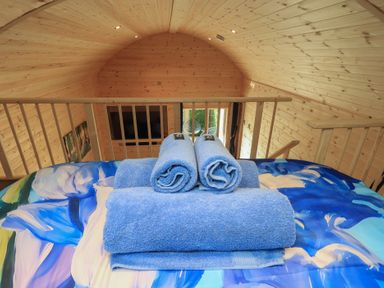 A loft with towels on a bed at Bluebelle - Crossgate Luxury Glamping, Hartsop