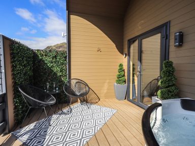 A balcony with chairs and a hot tub at Bluebelle - Crossgate Luxury Glamping Hartsop