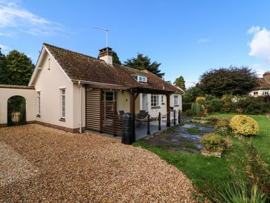 A house with a garden and patio at Barton Lodge in Porlock