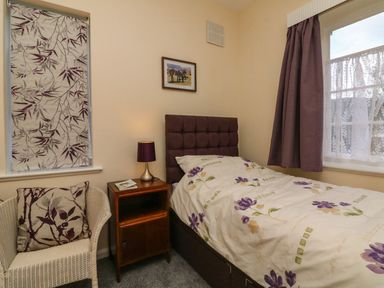 A bedroom with a single bed and window at Barton Lodge in Porlock