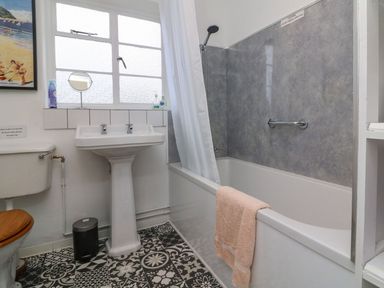 A bathroom with a sink, shower, and bathtub at Barton Lodge in Porlock