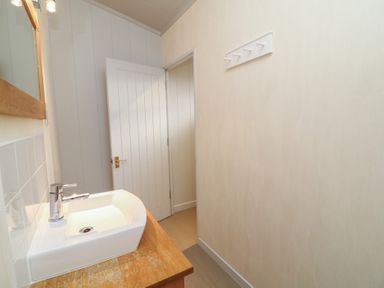 A bathroom with sink and mirror at Fairways 22 in Lincoln