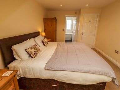A bedroom with a bed and wardrobe at 35 Longbeach Drive