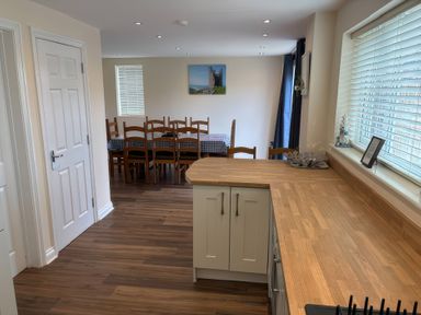 A kitchen with a dining area featuring a table and chairs at Nautilus in Beadnell