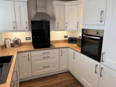 A kitchen with cabinets and appliances at Nautilus Beadnell