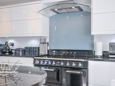 A kitchen with a SMEG oven and various containers at The Cowshed in Portscatho