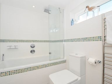 A bathroom with a bathtub and shower at The Cowshed in Portscatho