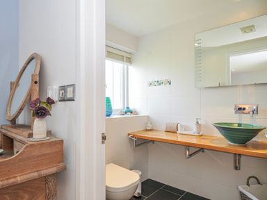 A bathroom with a sink and toilet at The Cowshed in Portscatho