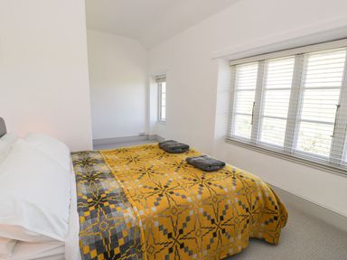 A bedroom with a bed and window light at Ty Mawr Farm Llanfairpwllgwyngyll