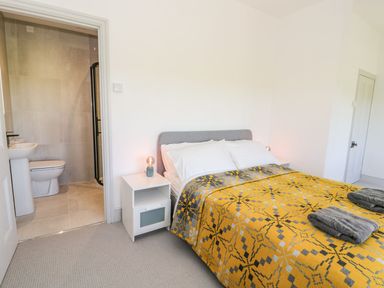 A bedroom with a bed and adjoining bathroom at Ty Mawr Farm in Llanfairpwllgwyngyll