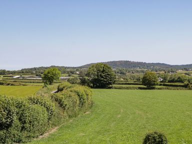 A landscape view of fields and trees at Ty Mawr Farm in Llanfairpwllgwyngyll