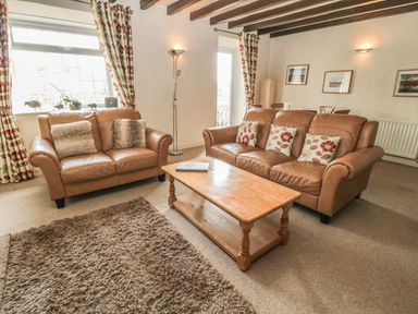 A living room with sofas and a coffee table at Shepherds Nook in Chathill