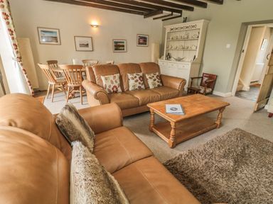 A living room with a sofa and coffee table at Shepherds Nook in Chathill