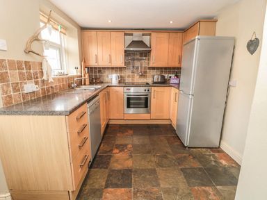 A kitchen with cabinets and appliances at Shepherds Nook in Chathill
