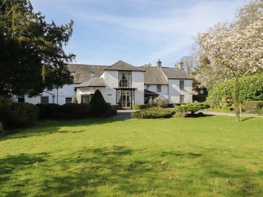 A house with a garden and trees at Plas Dolguog in Machynlleth