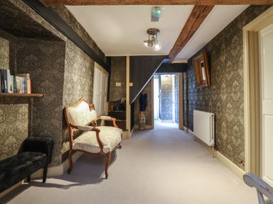A hallway with furniture and decor at Plas Dolguog in Machynlleth