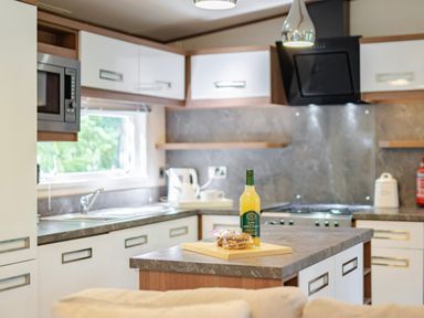 A kitchen with a stove and sink at Fern View -Kelling Heath Holiday Park Weybourne near Sheringham