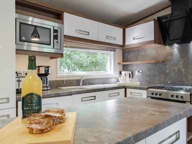 A kitchen with a microwave and coffee maker at Fern View -Kelling Heath Holiday Park Weybourne near Sheringham