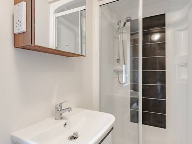A bathroom with a sink and shower at Fern View -Kelling Heath Holiday Park in Weybourne near Sheringham