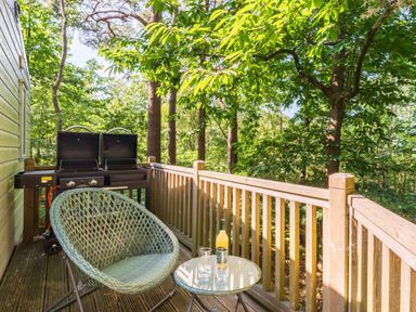 An outdoor area with a chair and table at Fern View -Kelling Heath Holiday Park in Weybourne near Sheringham