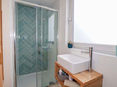 A bathroom with a shower and sink at La Casita in Newquay