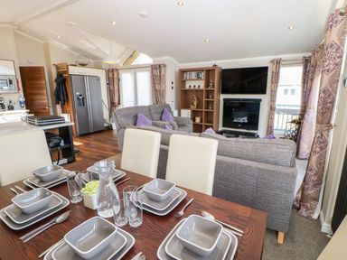 A dining room with a table set for meals at 37 Horizon Park in Hartlepool