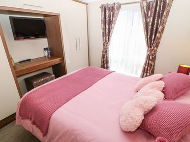 A bedroom with a bed and television at 37 Horizon Park in Hartlepool