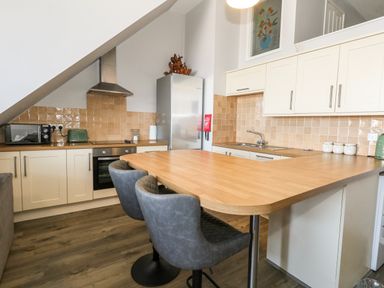 A kitchen with appliances and seating at Chandlers Nook in Portland