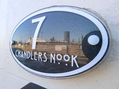 A nameplate with the text '7 Chandlers Nook' and a reflection at Chandlers Nook in Portland
