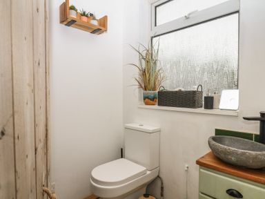 A bathroom with a toilet and sink at Bedford Cottage in Yelverton