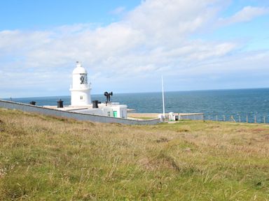 A lighthouse near the sea at Cape View in Cape Cornwall near St Just