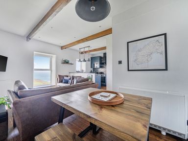 A living room with a sofa and table at Cape View near St Just