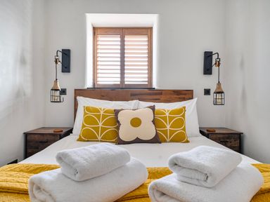 A bedroom with a bed and pillows at Cape View Cape Cornwall near St Just