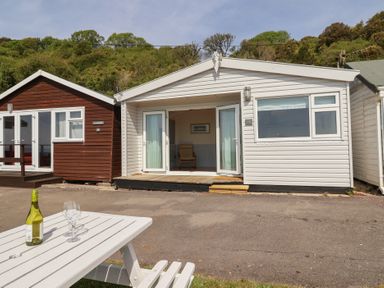 A cabin with a patio and furniture at Salt & Stone in Lyme Regis