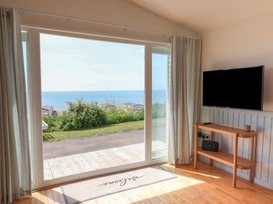 A living room with a view of the sea at Salt &amp; Stone in Lyme Regis