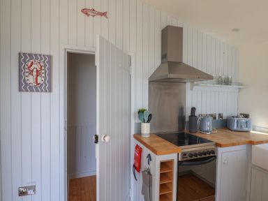 A kitchen with an oven and sink at Salt & Stone Lyme Regis