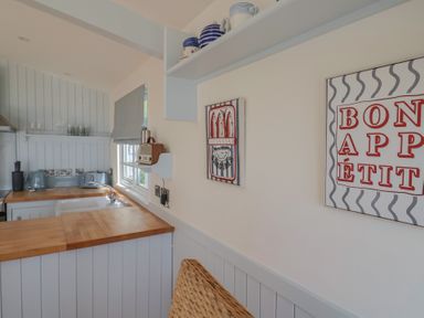 A kitchen with countertop, sink, and wall art at Salt & Stone Lyme Regis