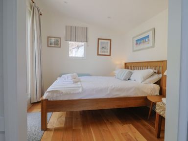 A bedroom with a bed and bedside table at Salt & Stone in Lyme Regis