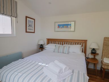 A bedroom with a bed and lamp at Salt & Stone Lyme Regis