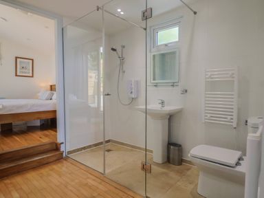 A bathroom with shower and sink at Salt & Stone Lyme Regis
