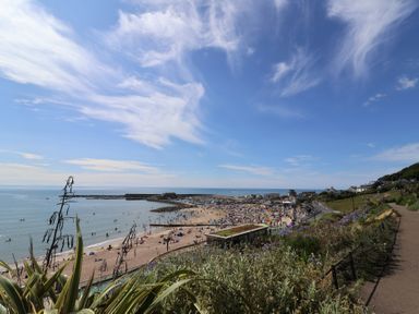 A beach with people near the ocean at Salt & Stone in Lyme Regis