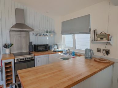 A kitchen with an oven and sink at Salt & Stone in Lyme Regis