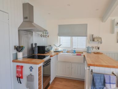 A kitchen with stove, sink, and kettle at Salt & Stone in Lyme Regis
