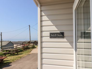 A view of the exterior signage for Salt & Stone in Lyme Regis