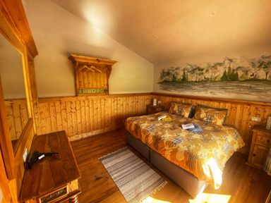 A bedroom with a bed and wooden furniture at No. 7 Enniskillen